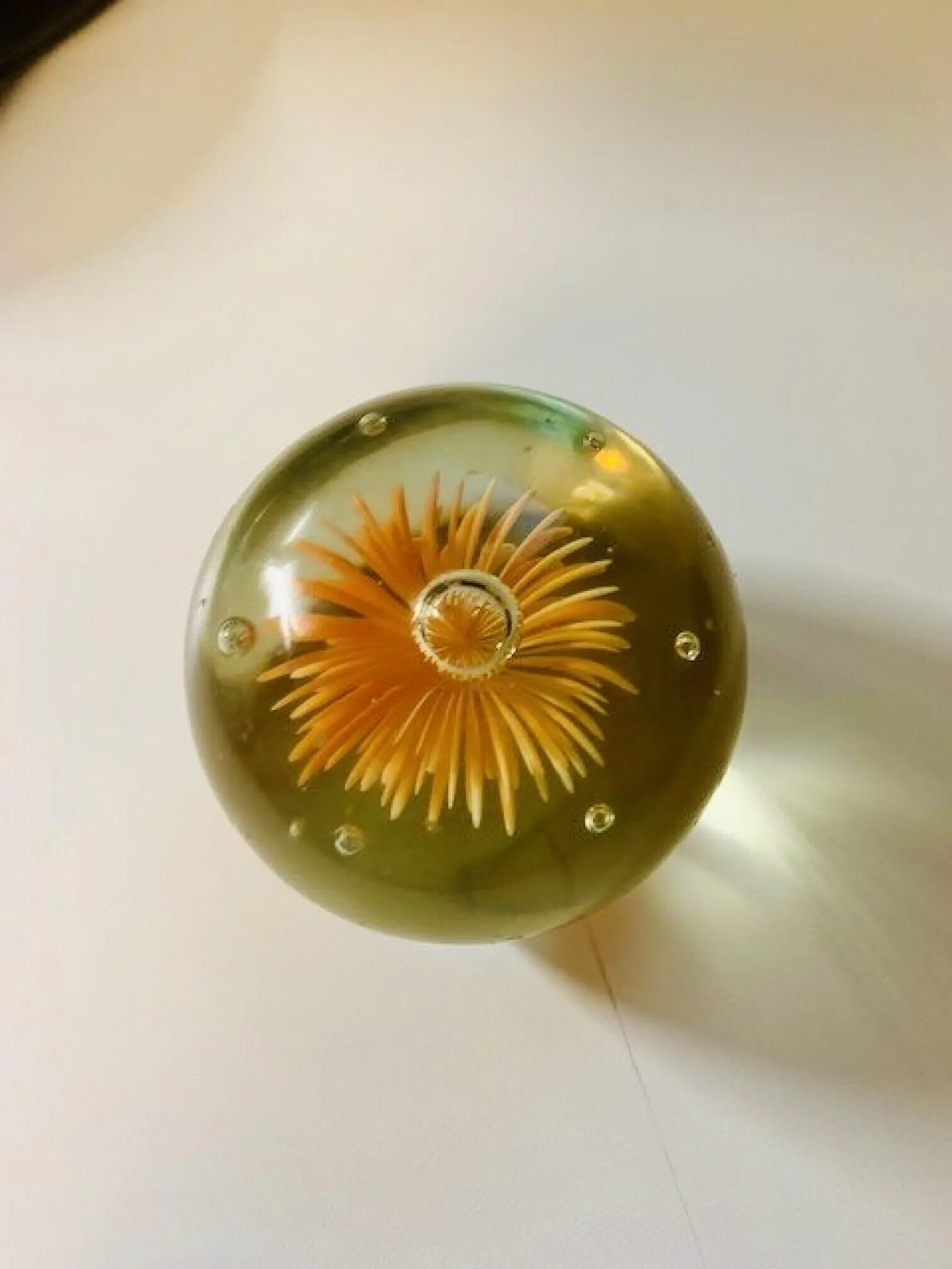 Glass paperweight with a flower inside of it