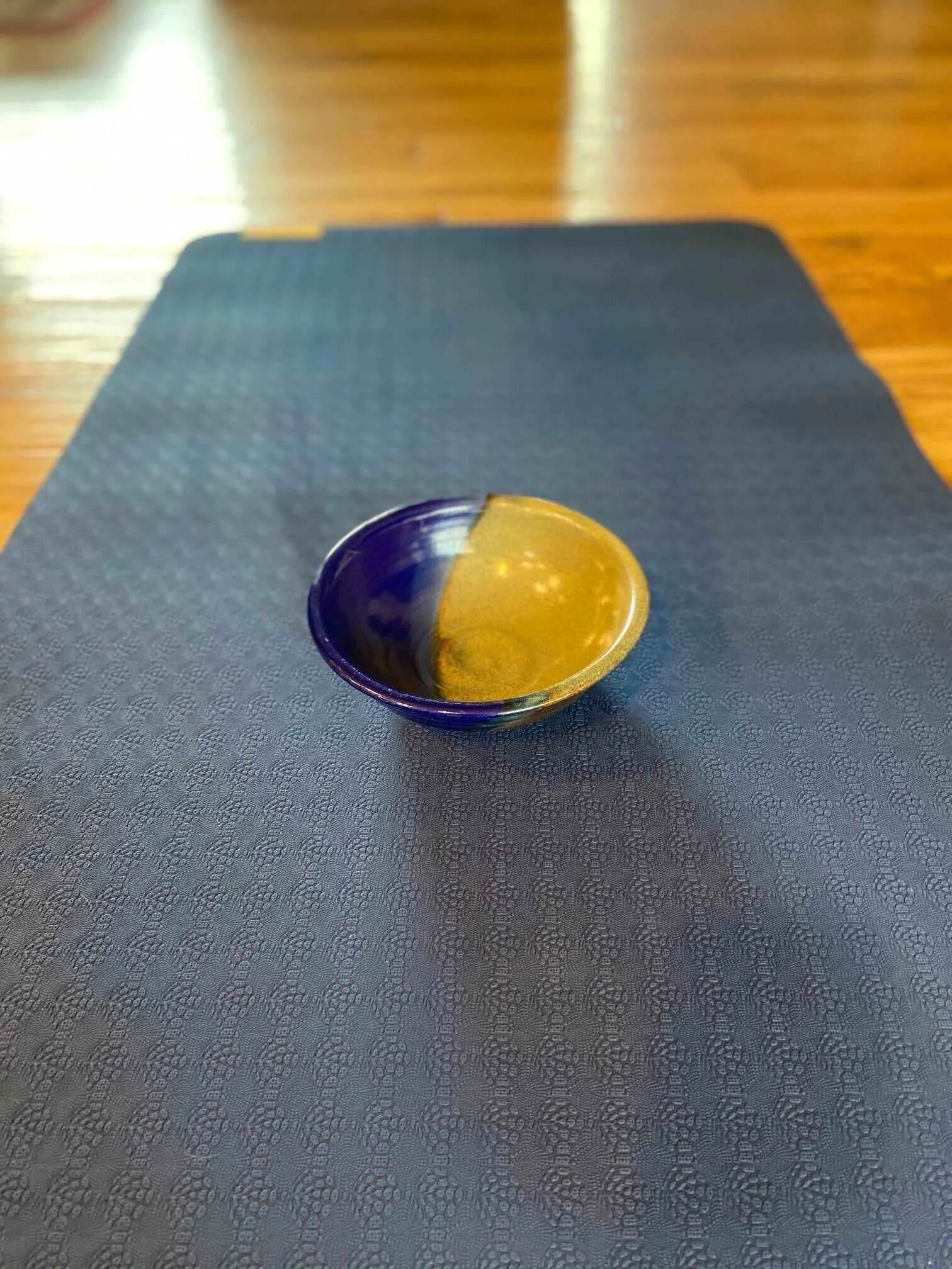 Ceramic bowl on a yoga mat